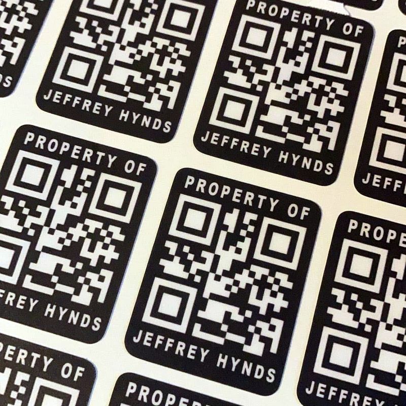 Sheet of black and white Property of QR code asset tag labels